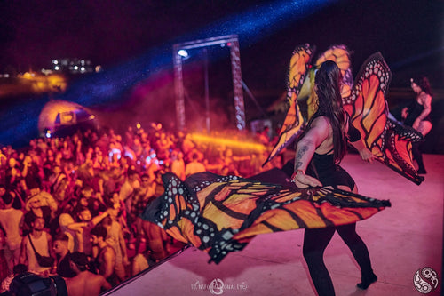 Utopia Party Koh Phangan – dancer with butterfly wings on the colourful stage in front of the crowd