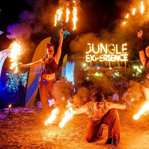 Jungle Experience Party Koh Phangan – fire performers in front of the Jungle Experience sign