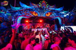 Jungle Experience Party Koh Phangan – arched stage with glowing eyes and the crowd with hands up