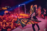 Utopia Party Koh Phangan – dancer with butterfly wings on the colourful stage in front of the crowd