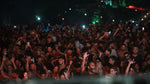 Utopia Party Koh Phangan – huge crowd dancing with hands in the air under red stage lights